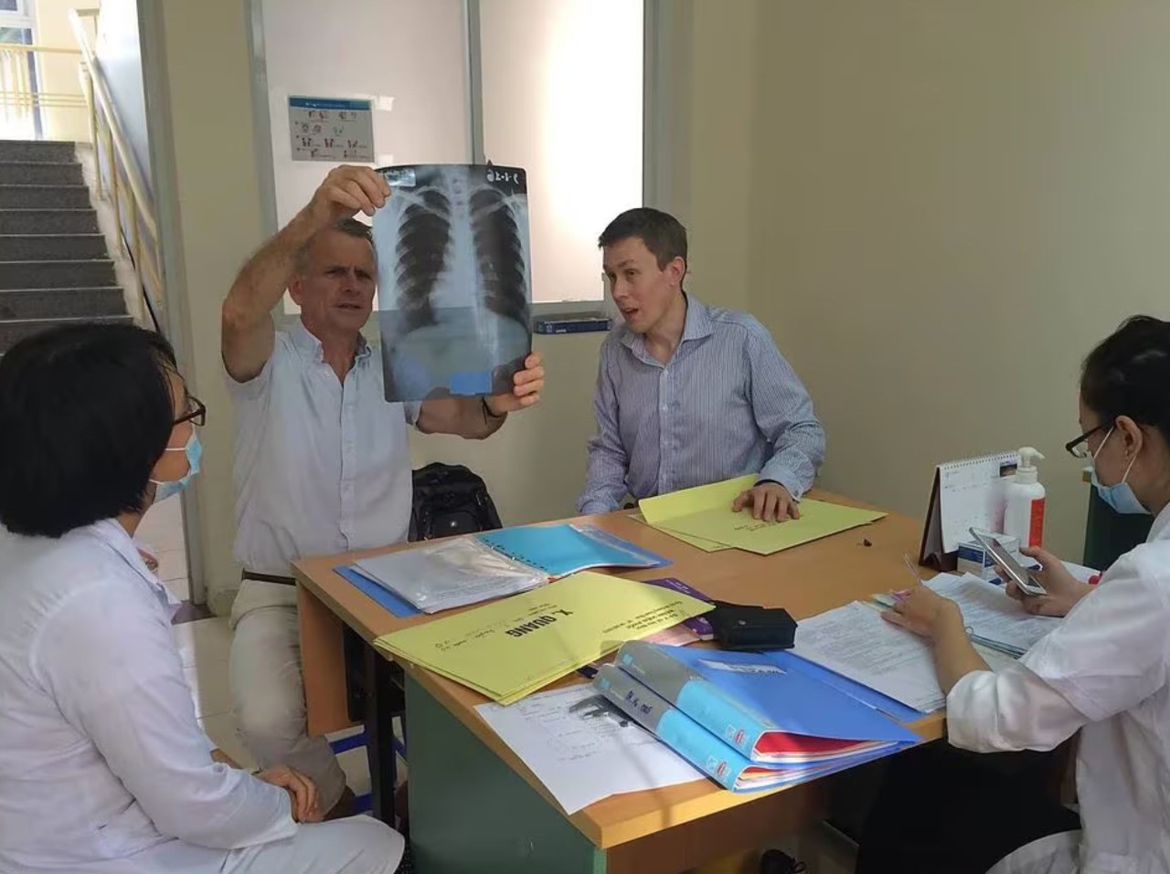 Professor Greg Fox (right) looking at an x-ray in Vietnam with collaborator Professor Dick Menzies, McGill University.